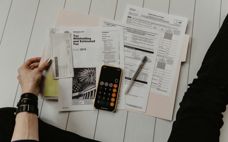 Bills, a calculator and a pen on a desk