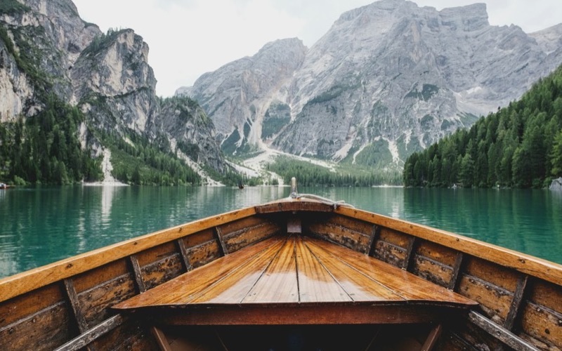 A wooden boat on a clear alpine lake